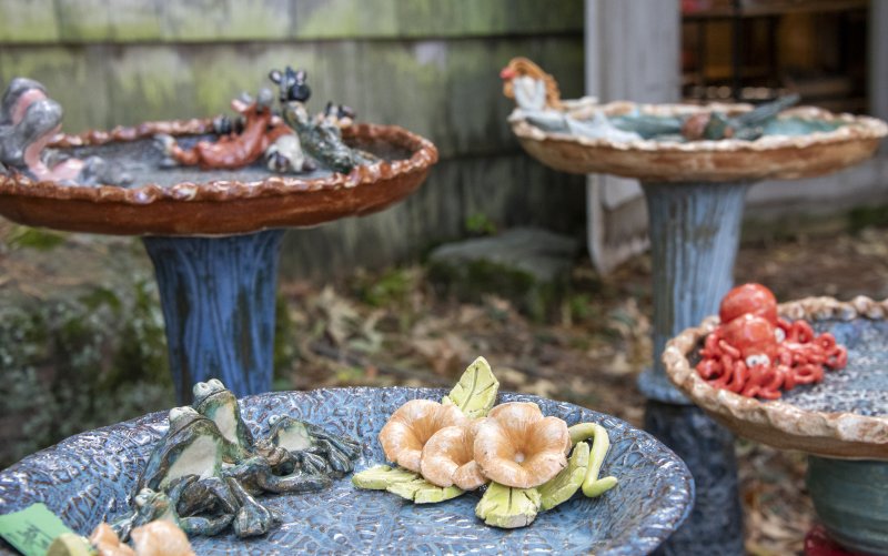 Cooley Ceramics bird baths sit among the pines at the Paynter Studio.